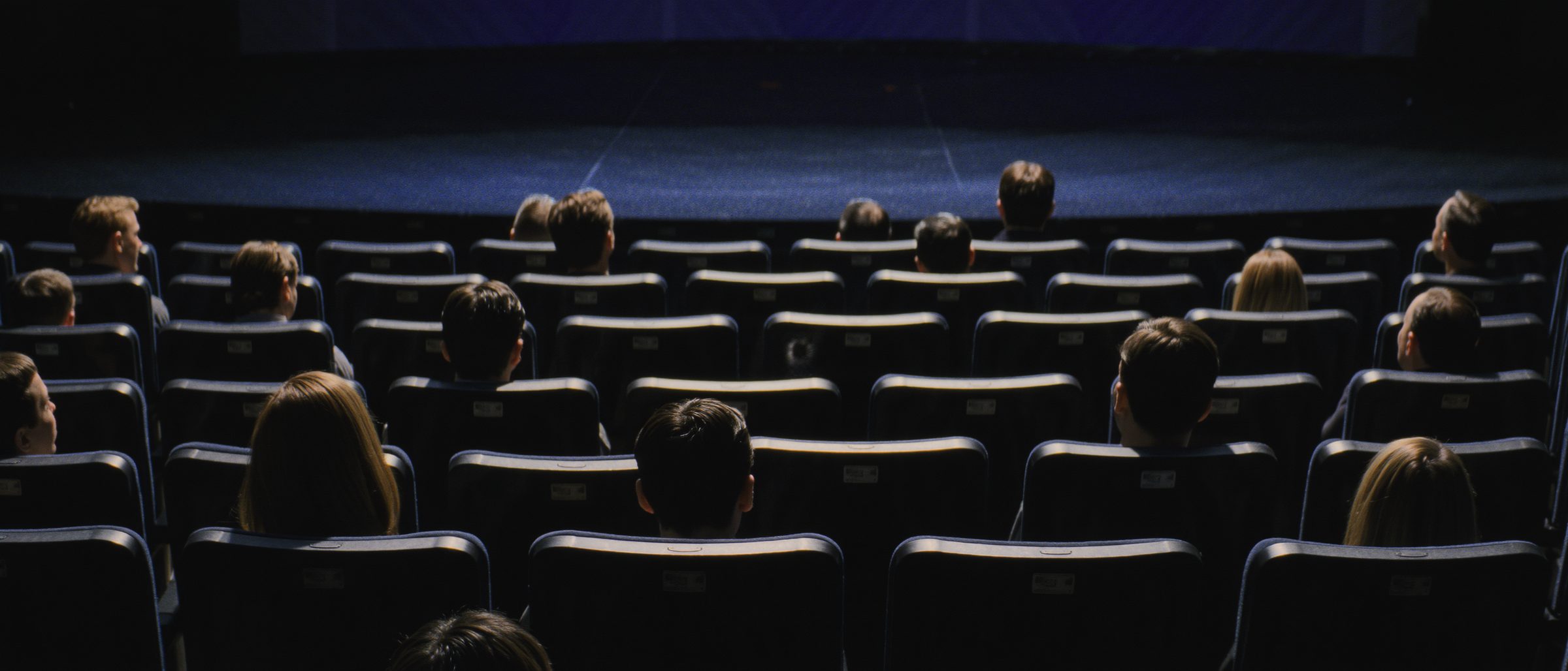 An audience in a dark theater
